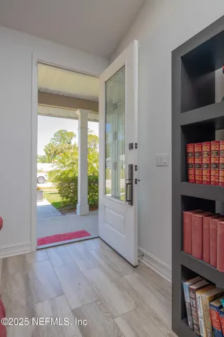a kitchen with granite countertop a sink a window and chairs