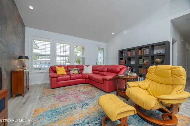 a room with lots of wooden furniture and view of living room