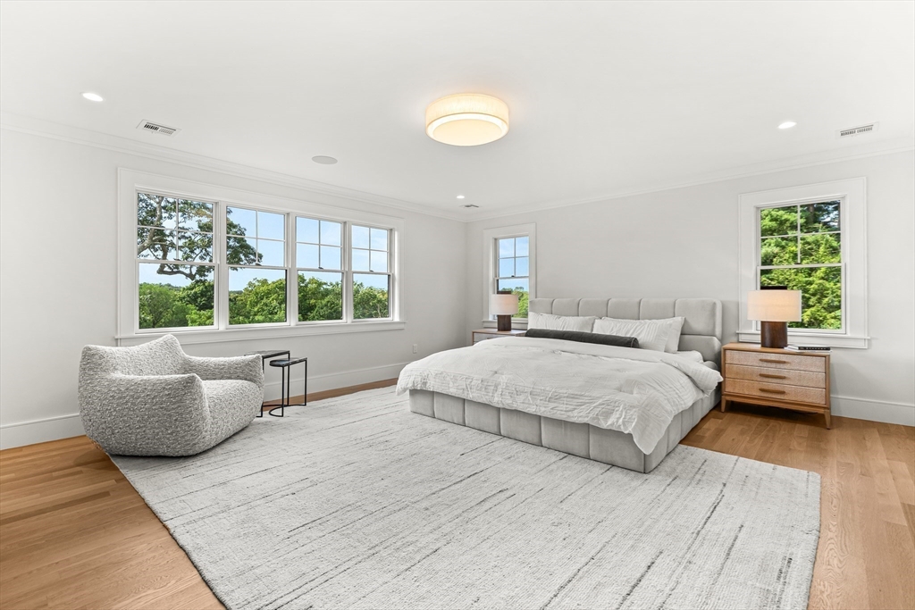 133 Lawton Road Needham, MA 02492 - Photo 16 of 36 a spacious bedroom with a bed and a large window