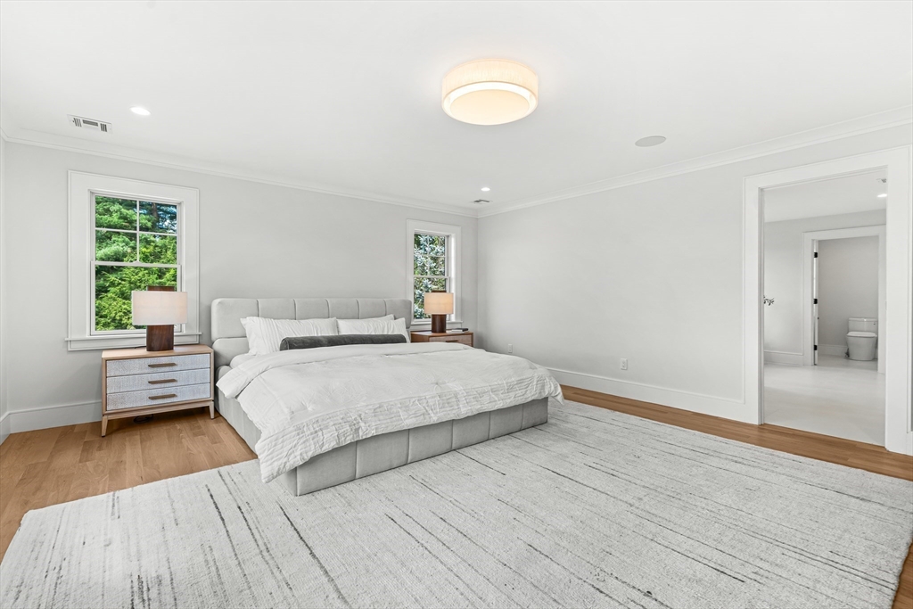 133 Lawton Road Needham, MA 02492 - Photo 18 of 36 a spacious bedroom with a bed and wooden floor