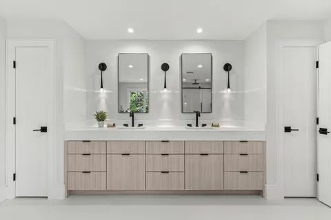 a bathroom with a double vanity sink a mirror and a