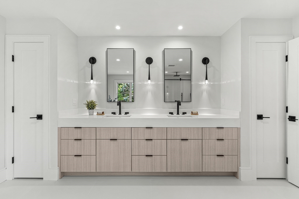 133 Lawton Road Needham, MA 02492 - Photo 19 of 36 a bathroom with a double vanity sink a mirror and a