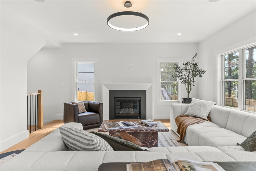 133 Lawton Road Needham, MA 02492 - Photo 2 of 36 a living room with furniture and a fireplace