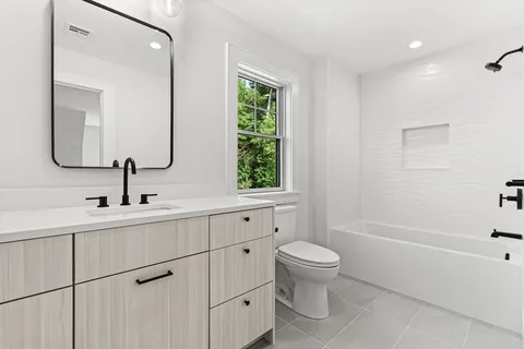 a bathroom with a toilet sink and mirror