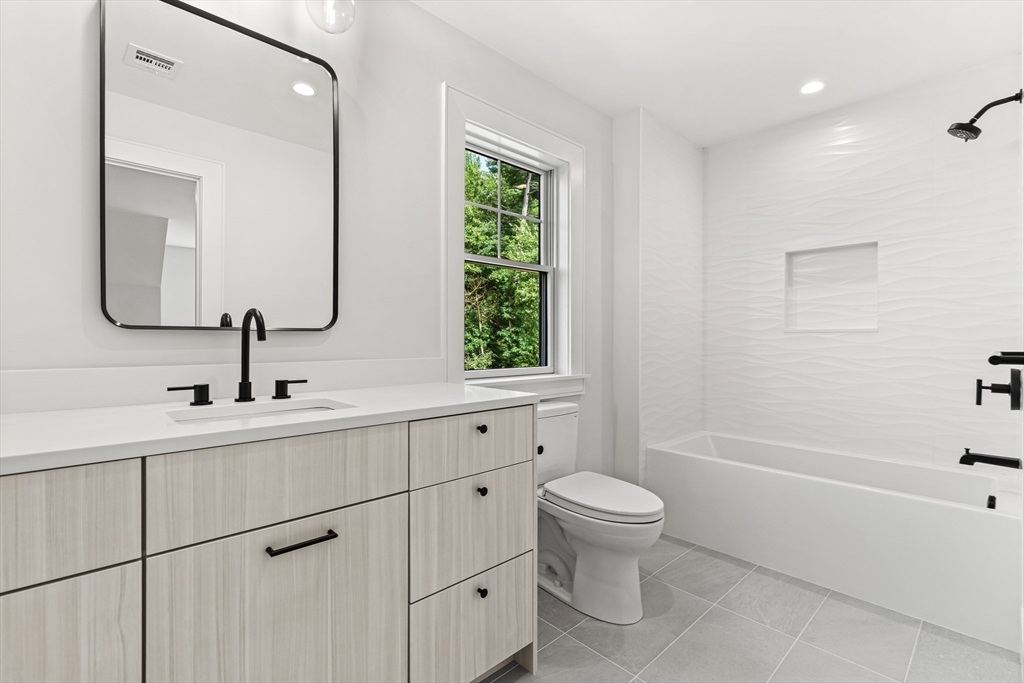 133 Lawton Road Needham, MA 02492 - Photo 25 of 36 a bathroom with a toilet sink and mirror