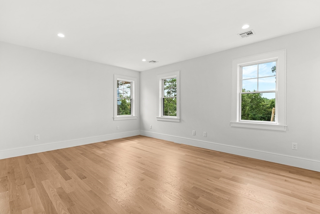 133 Lawton Road Needham, MA 02492 - Photo 26 of 36 an empty room with wooden floor and windows