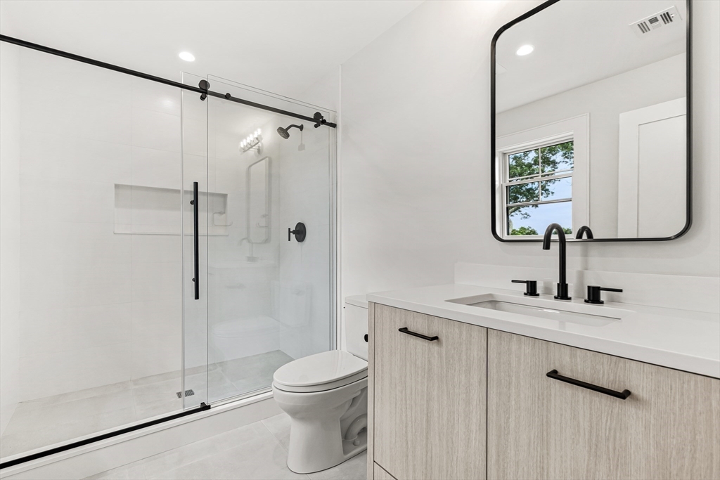 133 Lawton Road Needham, MA 02492 - Photo 27 of 36 a bathroom with a toilet sink and shower