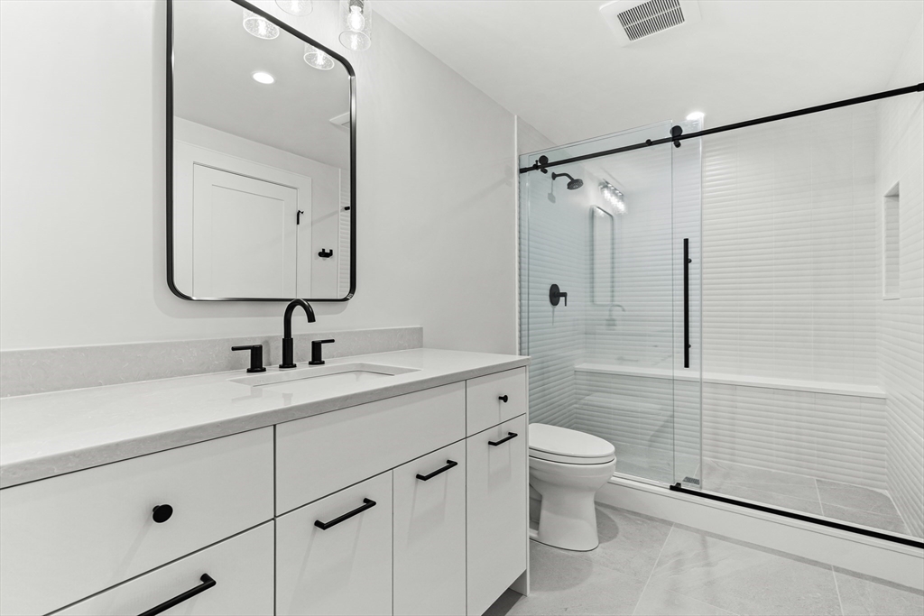 133 Lawton Road Needham, MA 02492 - Photo 31 of 36 a bathroom with a sink a toilet and shower