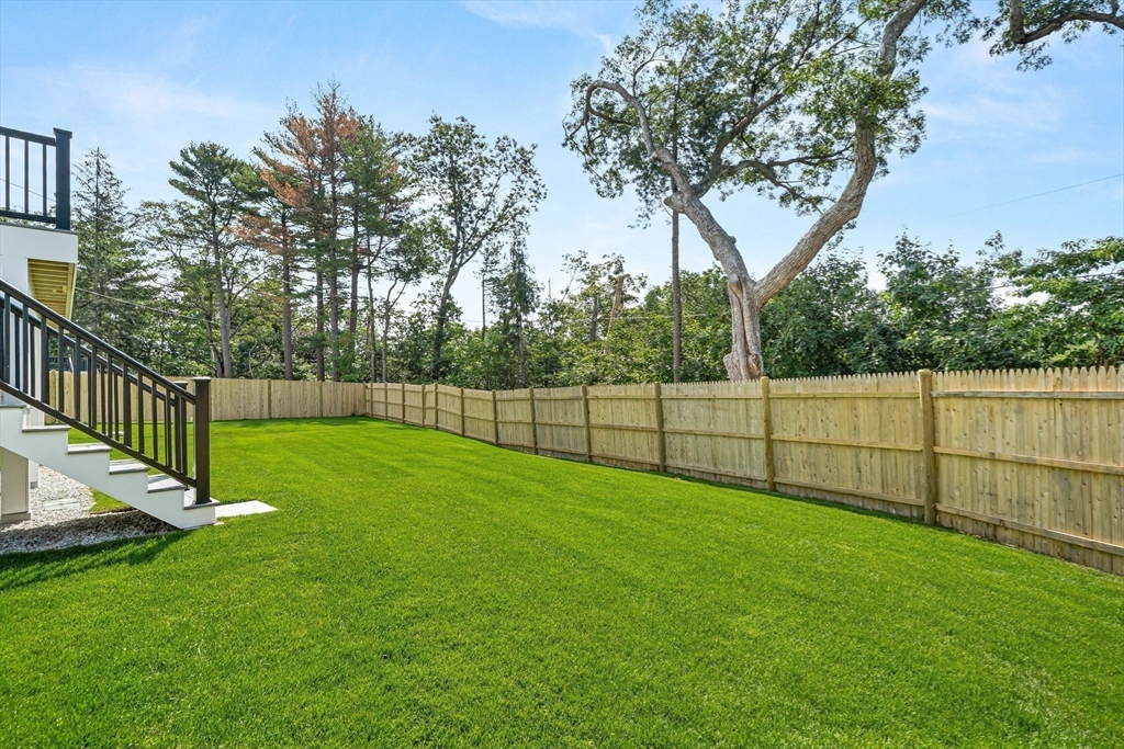133 Lawton Road Needham, MA 02492 - Photo 34 of 36 a view of a backyard with a fence and trees