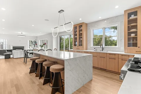 a kitchen with sink table and chairs