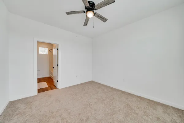 a view of a room with a ceiling fan
