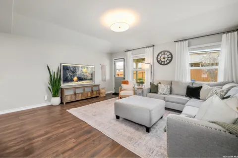 a living room with couches and a flat screen tv