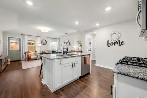 a kitchen with sink and cabinets