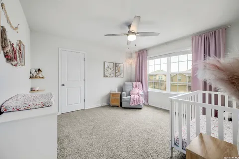 a bedroom with furniture and a large window