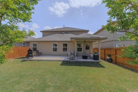 a front view of a house with patio and garden