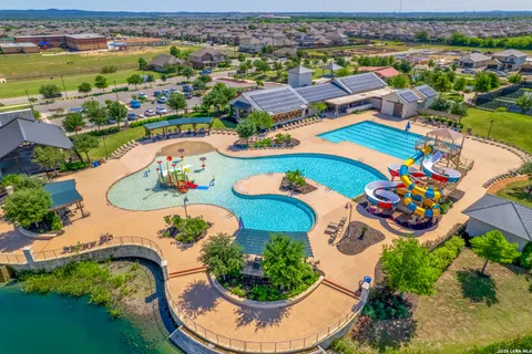 an aerial view of a swimming pool patio and outdoor seating