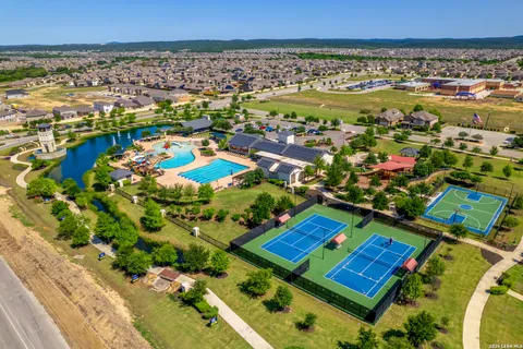 an aerial view of residential houses with outdoor space and swimming pool