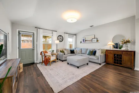 a living room with furniture and wooden floor