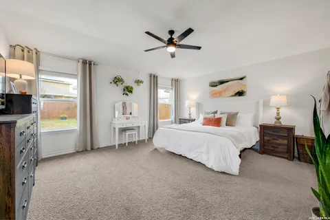 a bedroom with a bed dresser and a window