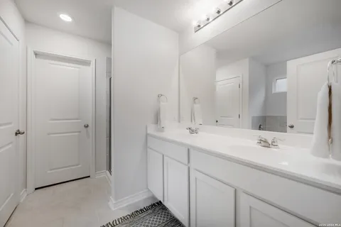 a bathroom with a double vanity sink mirror and