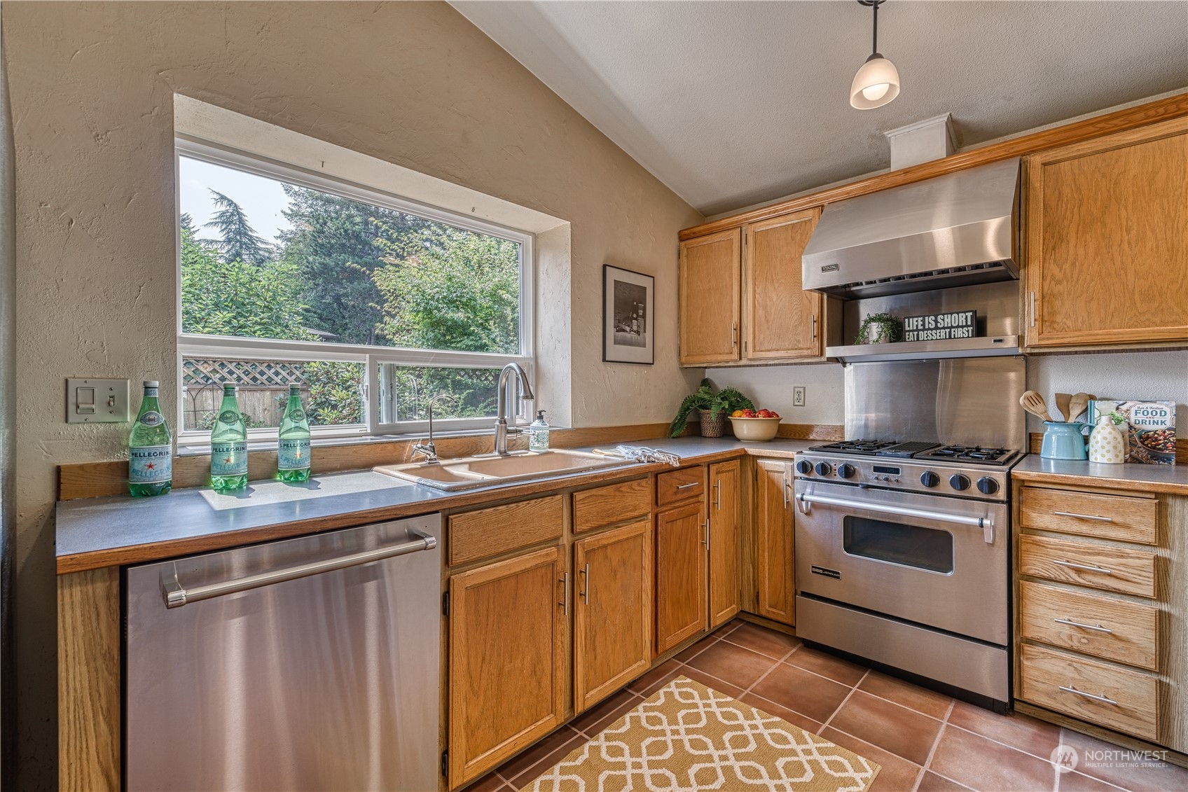 7720 Insel Avenue Gig Harbor, WA 98335 - Photo 12 of 29 a kitchen with a sink stove and cabinets