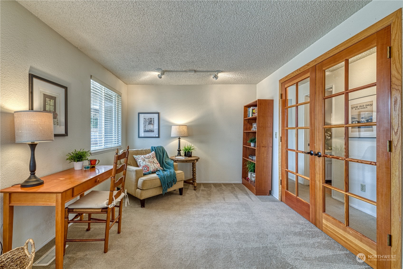 7720 Insel Avenue Gig Harbor, WA 98335 - Photo 16 of 29 a living room with furniture a lamp and a window