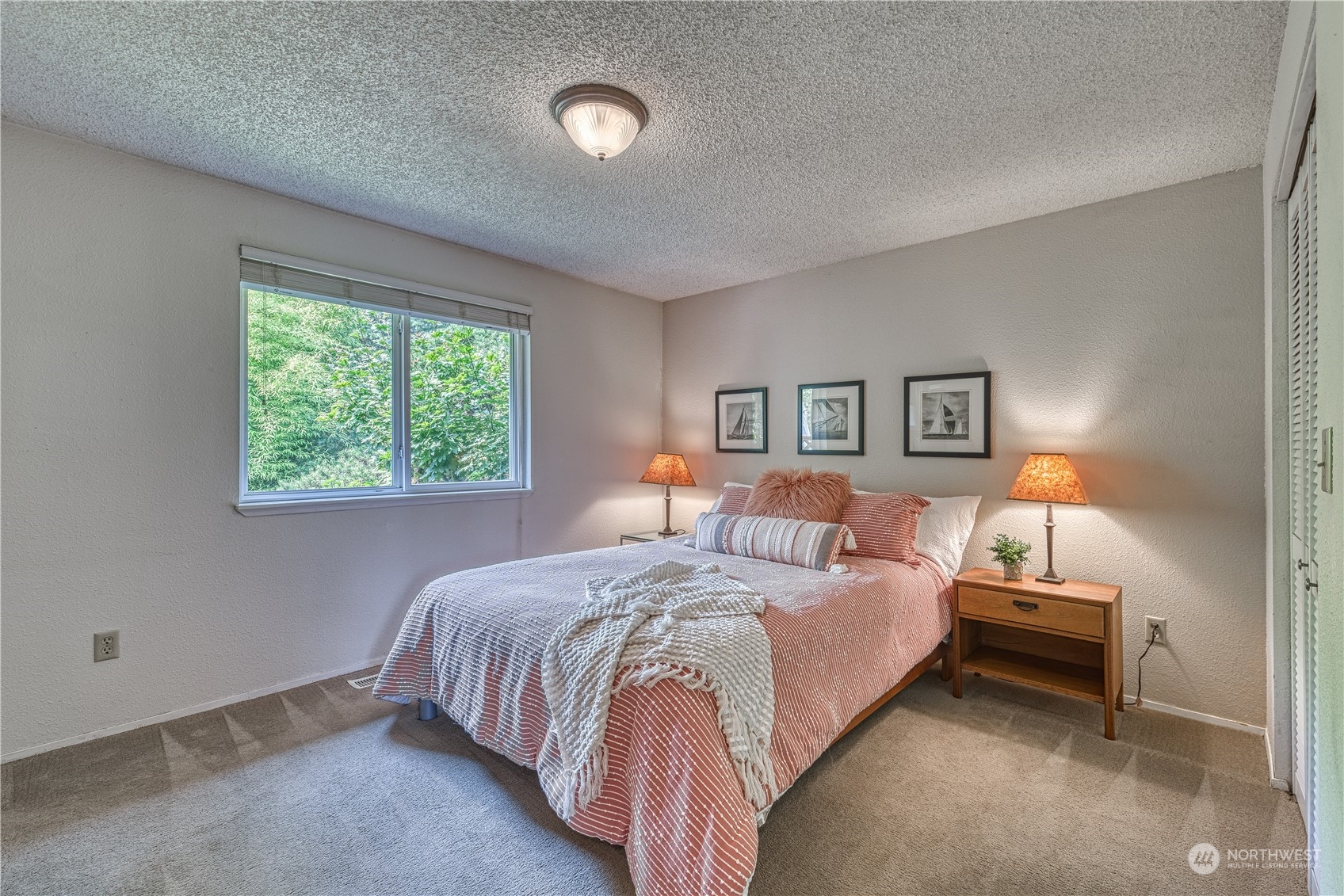 7720 Insel Avenue Gig Harbor, WA 98335 - Photo 19 of 29 a large bed sitting in a bedroom next to a window
