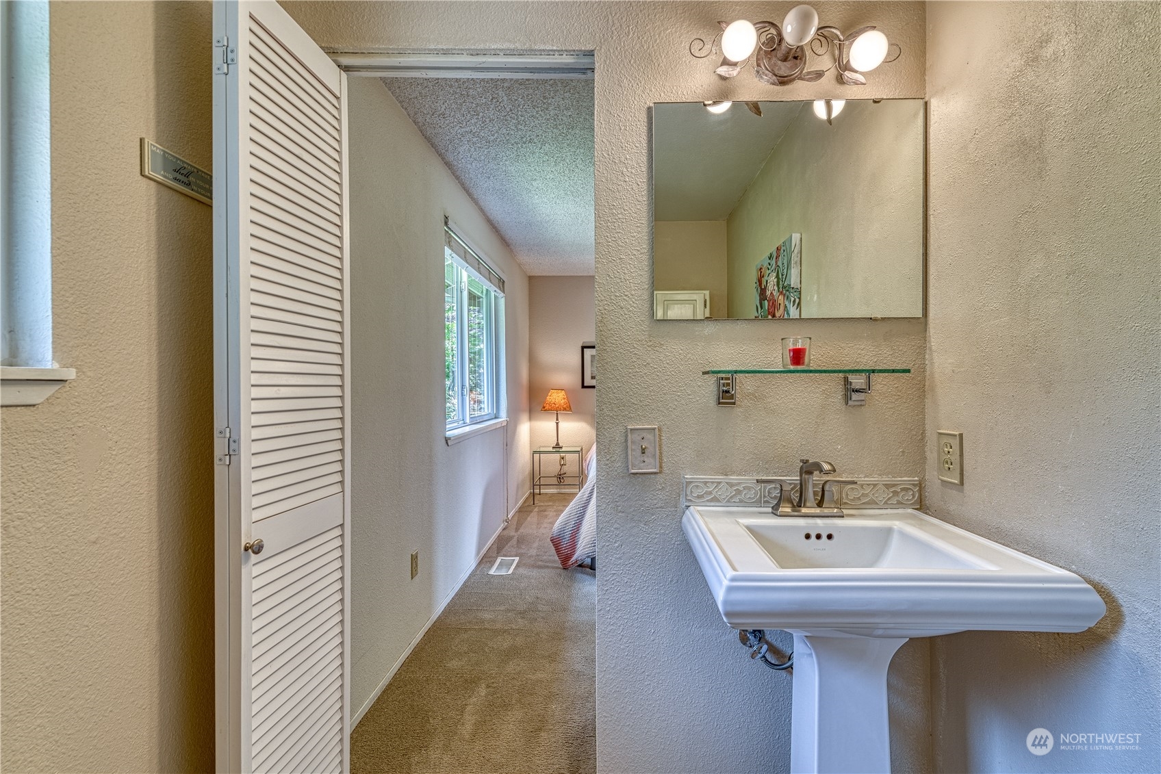 7720 Insel Avenue Gig Harbor, WA 98335 - Photo 23 of 29 a bathroom with a sink and a mirror