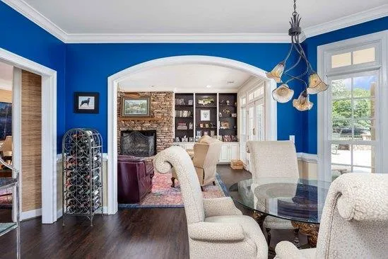 a living room with furniture a fireplace and a large window