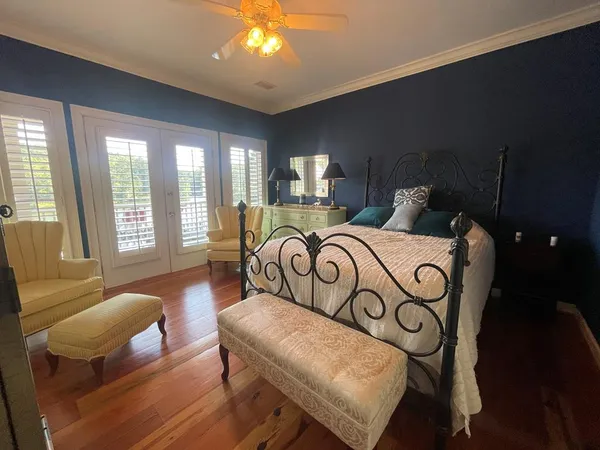 a bedroom with furniture and wooden floor