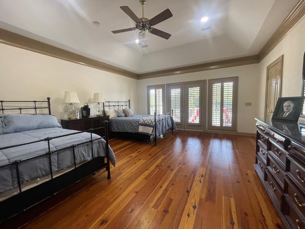 219 Broken Rock Road Hamilton, GA 31811 - Photo 27 of 44 a spacious bedroom with two beds and wooden floor
