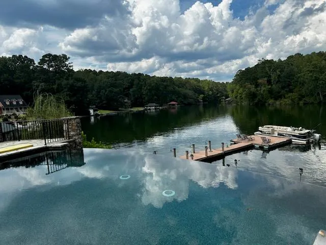 a view of a lake with cars parked