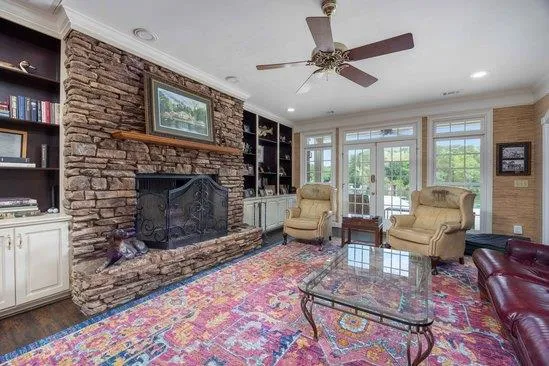 a living room with furniture a flat screen tv and a fireplace