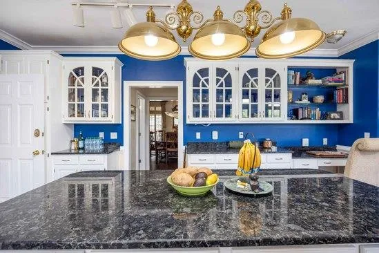 a kitchen with a wooden floor and breakfast area