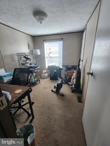 a view of a livingroom with furniture and a window