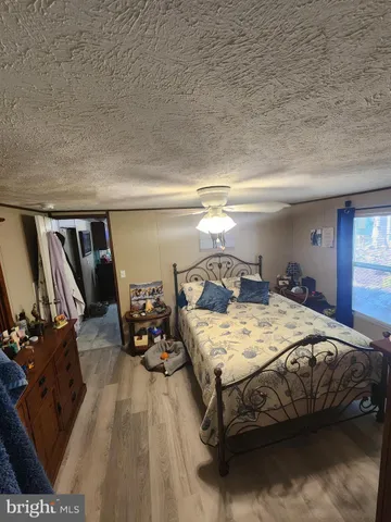 a bedroom with bed and window