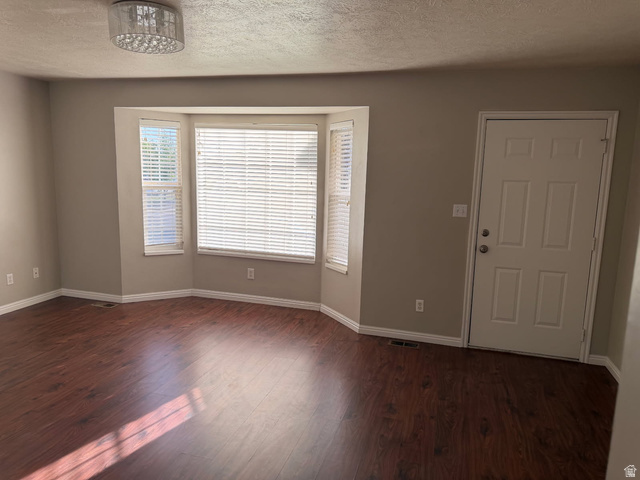 1563 South 600 East Springville, UT 84663 - Photo 3 of 30 Living area featuring a bay window with blinds, wood-finish flooring, and a flush-mount ceiling light fixture