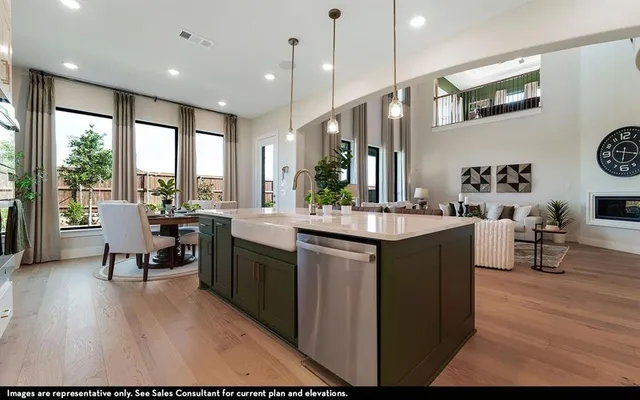 a kitchen with kitchen island granite countertop a sink a counter top space and stainless steel appliances