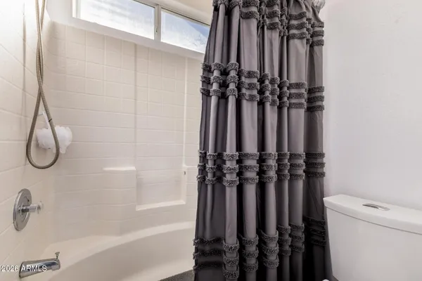 a bathroom with a sink double vanity mirror and a bathtub