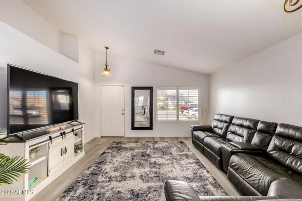 a living room with furniture chandelier and a couch