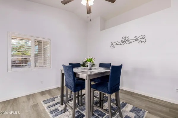 a view of a dining room with furniture and wooden floor