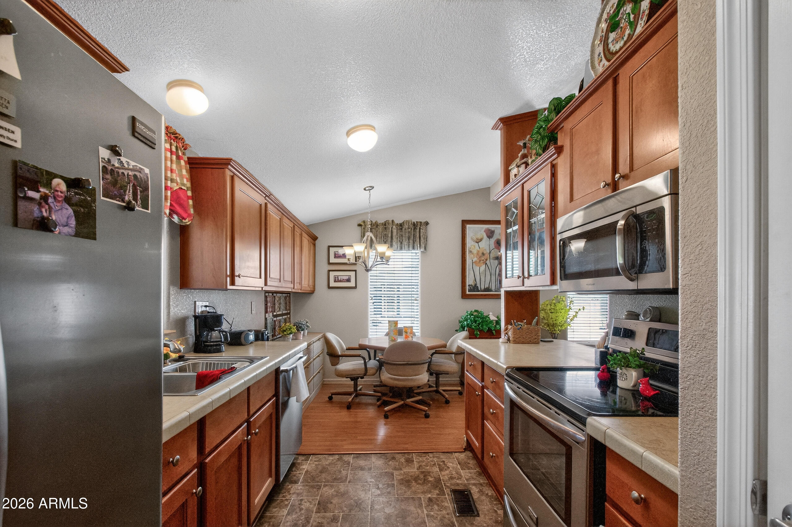 5735 East McDowell Road, Unit 408 Mesa, AZ 85215 - Photo 12 of 42 a kitchen with stainless steel appliances granite countertop a stove and a refrigerator