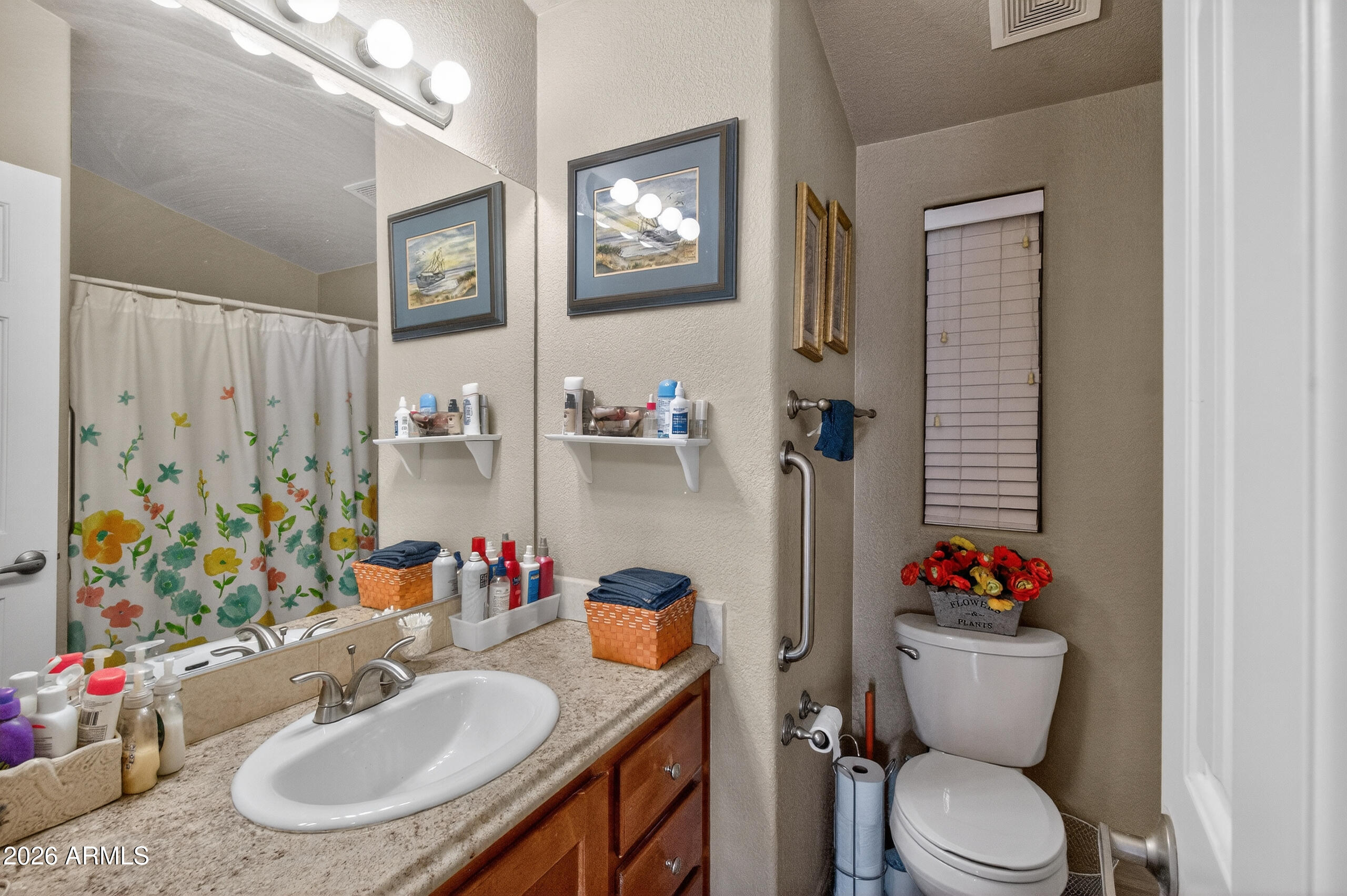 5735 East McDowell Road, Unit 408 Mesa, AZ 85215 - Photo 15 of 42 a bathroom with a sink toilet and a mirror