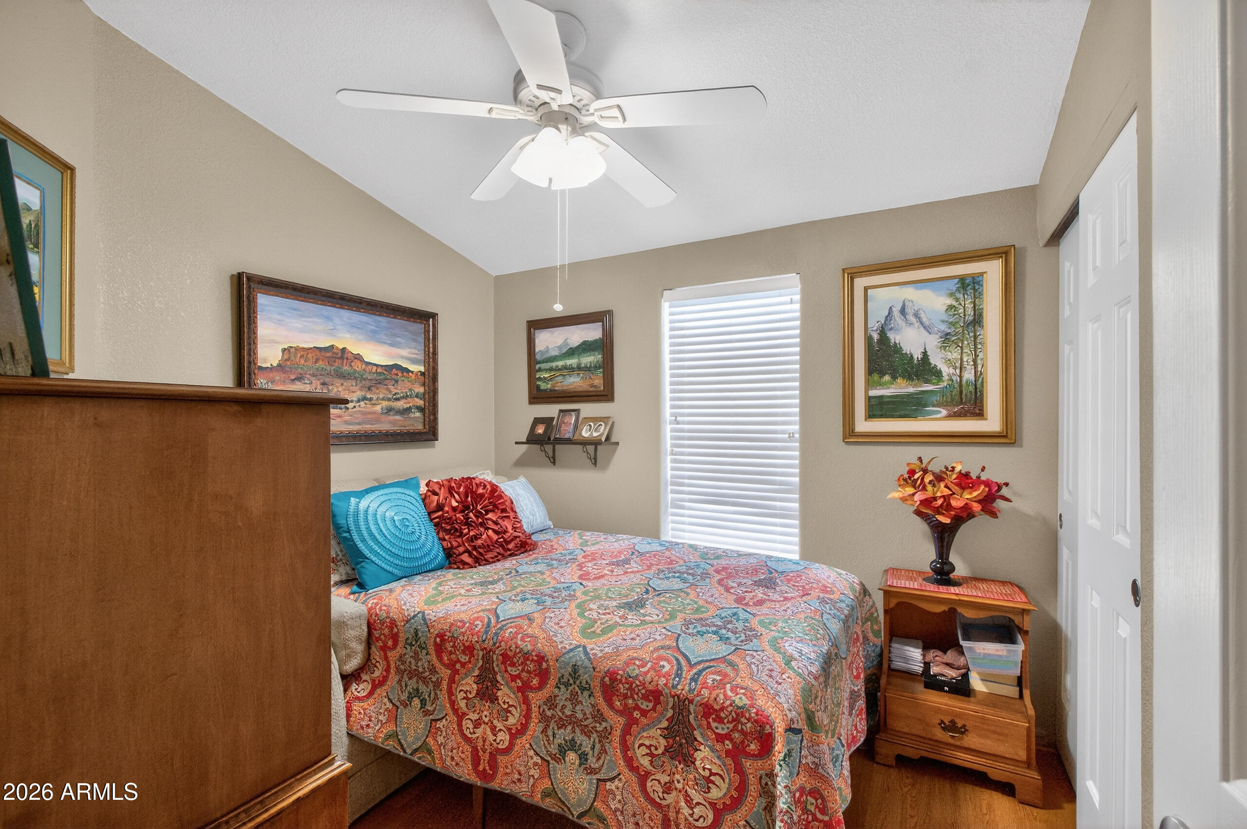 5735 East McDowell Road, Unit 408 Mesa, AZ 85215 - Photo 16 of 42 a bedroom with a large bed and a chandelier