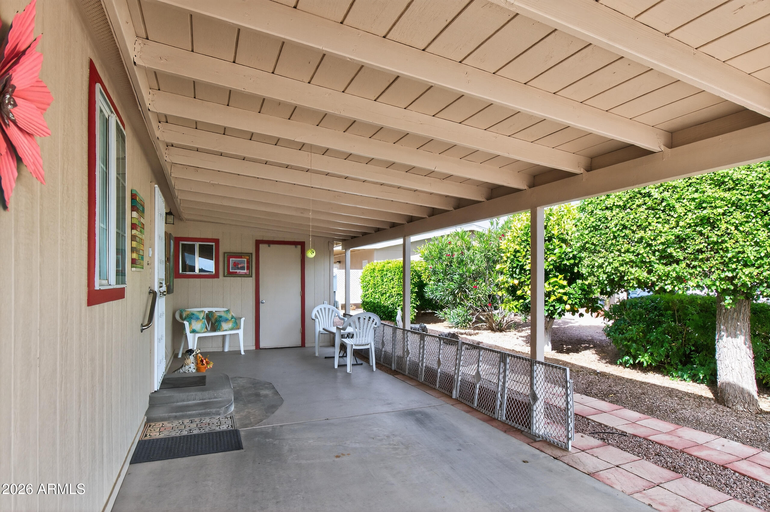 5735 East McDowell Road, Unit 408 Mesa, AZ 85215 - Photo 19 of 42 a view of a porch with furniture and garden