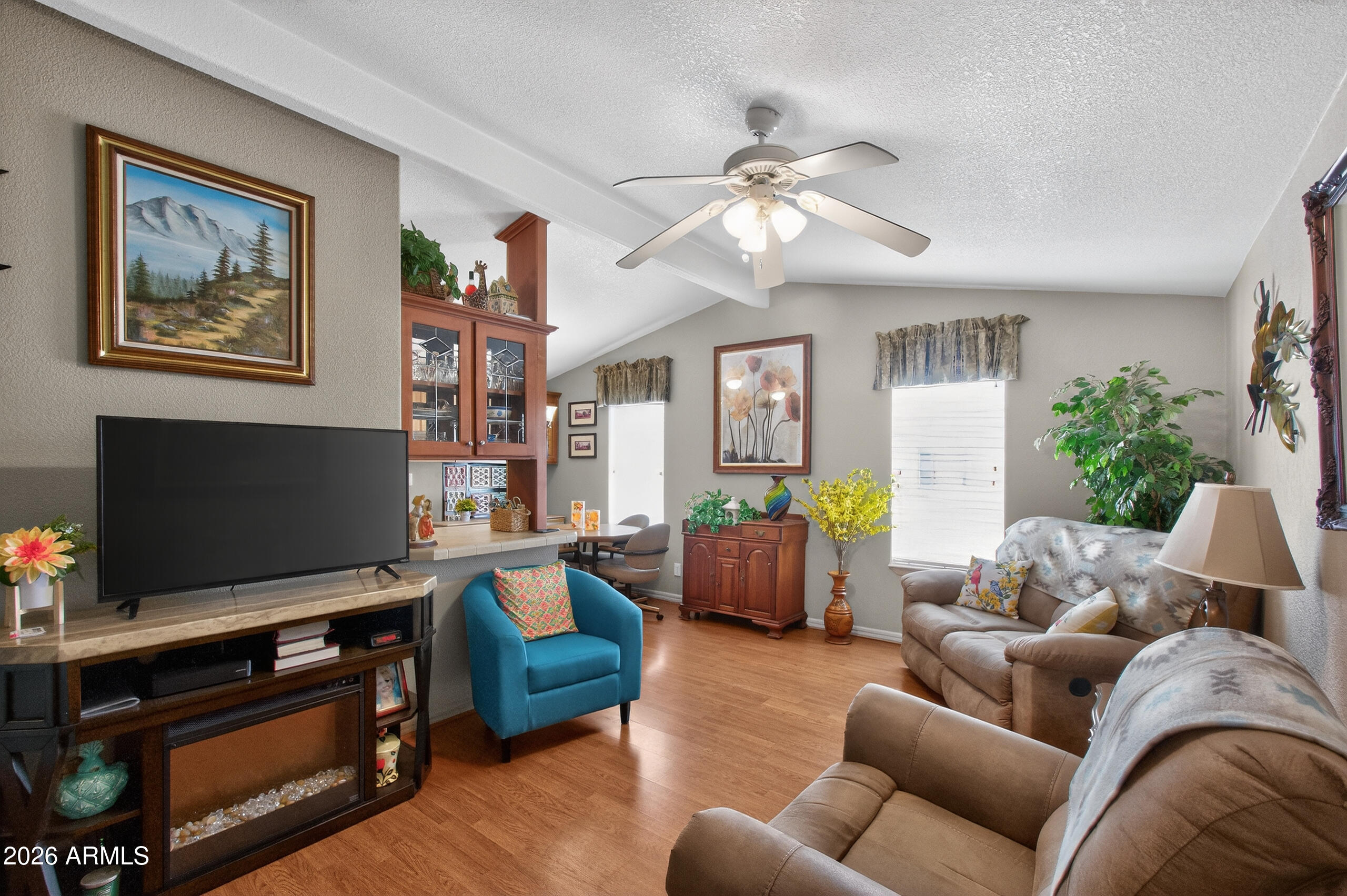 5735 East McDowell Road, Unit 408 Mesa, AZ 85215 - Photo 3 of 42 a living room with furniture and a flat screen tv