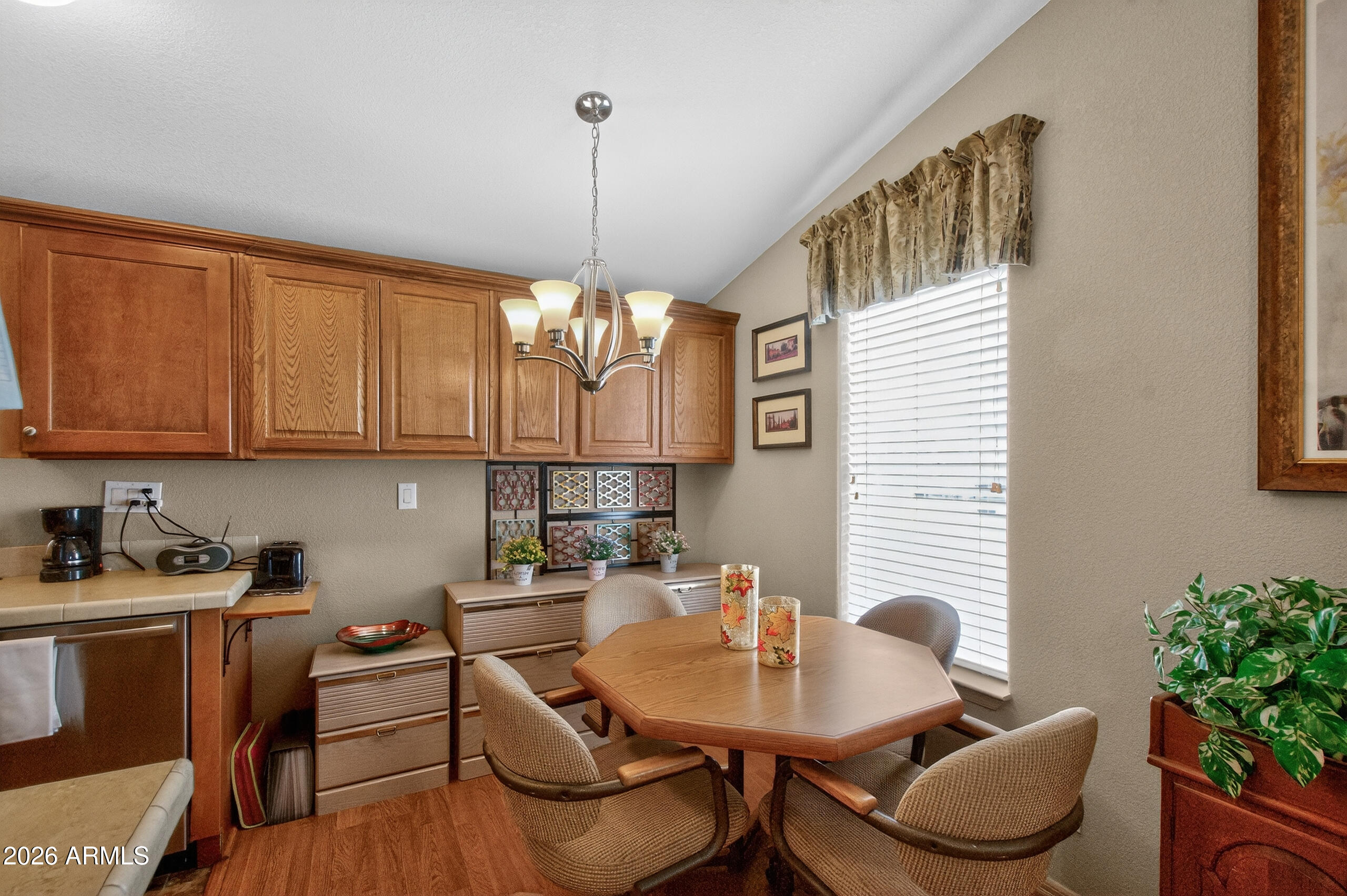 5735 East McDowell Road, Unit 408 Mesa, AZ 85215 - Photo 7 of 42 a kitchen with a table and chairs in it
