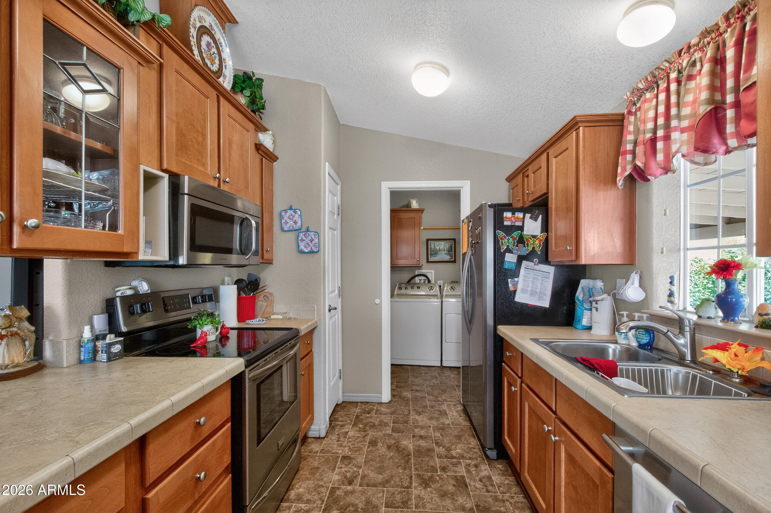 5735 East McDowell Road, Unit 408 Mesa, AZ 85215 - Photo 9 of 42 a kitchen with stainless steel appliances granite countertop a sink stove and cabinets