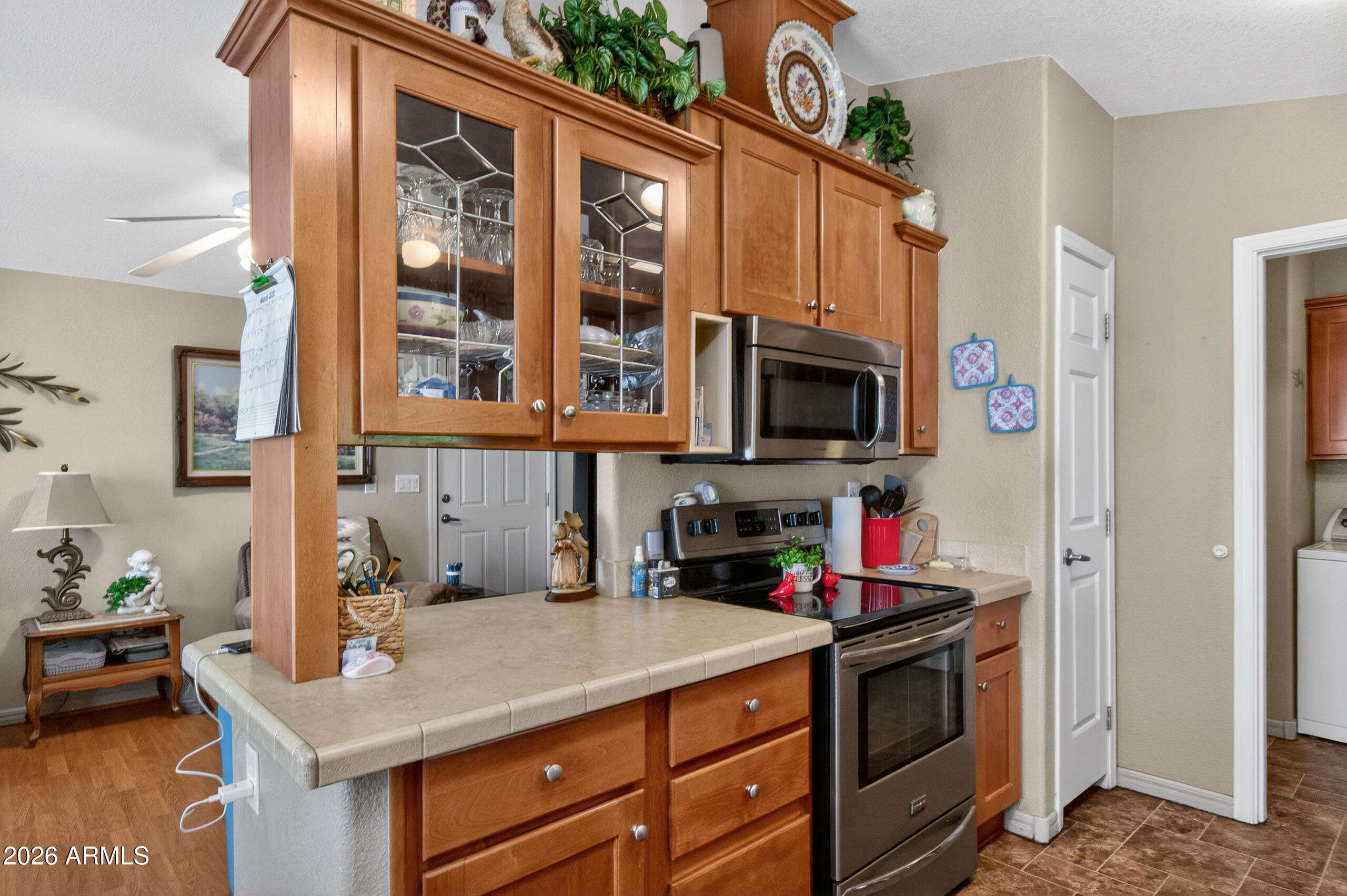 5735 East McDowell Road, Unit 408 Mesa, AZ 85215 - Photo 10 of 42 a kitchen with stainless steel appliances granite countertop a sink and a refrigerator