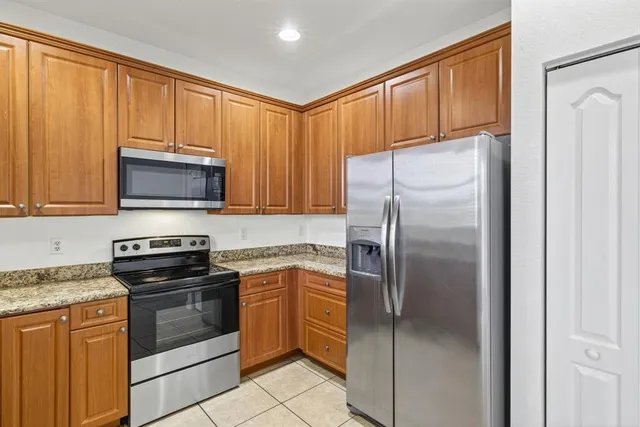 a kitchen with granite countertop stainless steel appliances and cabinets